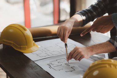 Architects and engineers are working together to edit the draft house plan that was designed after it was presented to the client and partially revised the design. Interior design and decoration ideas