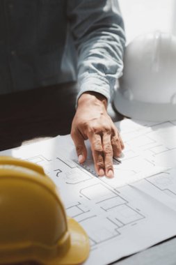 Architects and engineers are working together to edit the draft house plan that was designed after it was presented to the client and partially revised the design. Interior design and decoration ideas