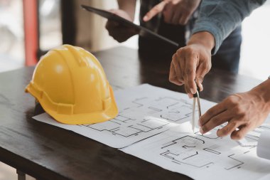 Architects and engineers are working together to edit the draft house plan that was designed after it was presented to the client and partially revised the design. Interior design and decoration ideas