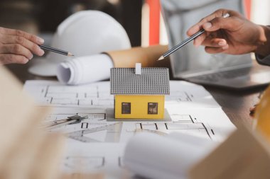 Architects and engineers are working together to edit the draft building plan that was designed after it was presented to the client and partially revised the design. Interior design and decoration ideas