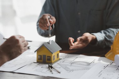 Architects and engineers are working together to edit the draft building plan that was designed after it was presented to the client and partially revised the design. Interior design and decoration ideas