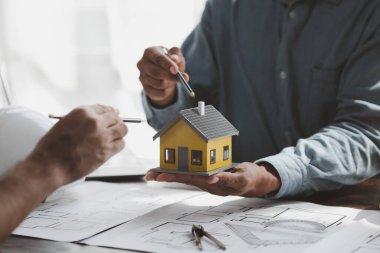 Architects and engineers are working together to edit the draft building plan that was designed after it was presented to the client and partially revised the design. Interior design and decoration ideas