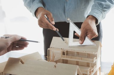 Architects and engineers are working together to edit the draft building plan that was designed after it was presented to the client and partially revised the design. Interior design and decoration ideas