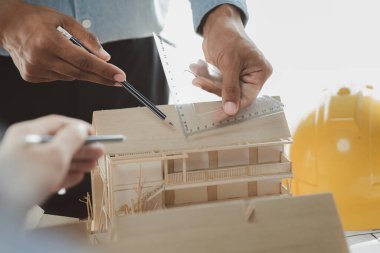 Architects and engineers are working together to edit the draft building plan that was designed after it was presented to the client and partially revised the design. Interior design and decoration ideas