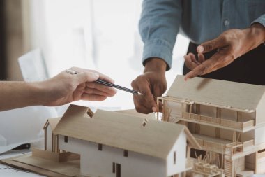 Architects and engineers are working together to edit the draft building plan that was designed after it was presented to the client and partially revised the design. Interior design and decoration ideas