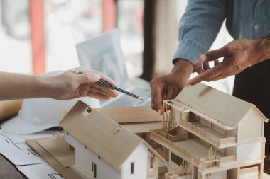 Architects and engineers are working together to edit the draft building plan that was designed after it was presented to the client and partially revised the design. Interior design and decoration ideas