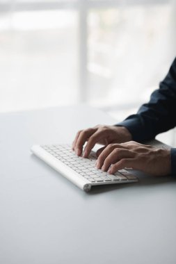 Bir bilgisayar klavyesinde yazan kişi, iş adamı bir şirkette çalışıyor, iş arkadaşlarına mesajlar yazıyor ve toplantıları özetliyor. Boşluğu kopyala.
