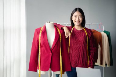Beautiful girl clothing designer, the owner of the shop, she is the owner of a female fashion clothing store and designs clothes by herself, selling products through online websites.