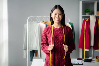 Beautiful girl clothing designer, the owner of the shop, she is the owner of a female fashion clothing store and designs clothes by herself, selling products through online websites.