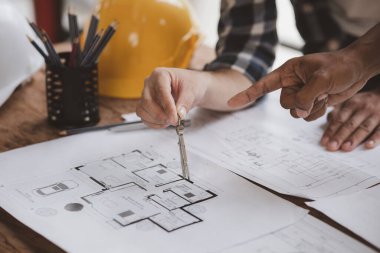 Architects and engineers are working together to edit the draft house plan that was designed after it was presented to the client and partially revised the design. Interior design and decoration ideas