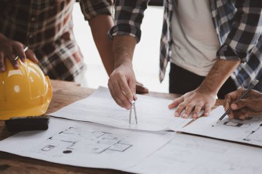Architects and engineers are working together to edit the draft house plan that was designed after it was presented to the client and partially revised the design. Interior design and decoration ideas