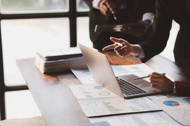 The sales department is having a monthly summary meeting to bring it to the department manager, they are verifying the correctness of the documents that are prepared before bringing in to the manager