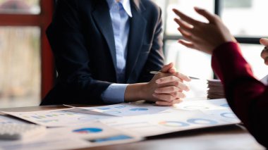 The sales department is having a monthly summary meeting to bring it to the department manager, they are verifying the correctness of the documents that are prepared before bringing in to the manager