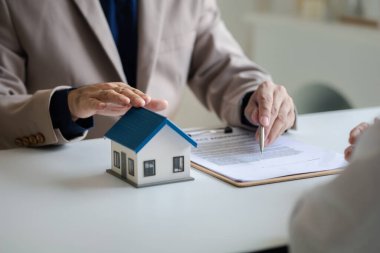 Emlakçılar, konut modellerini müşterilere ayrıntılı bir şekilde anlatma, evler ve satın alma kredileri hakkında bilgi verme ve sunma konularında açıklar. Gayrimenkul ticareti.