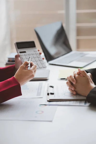 stock image Two businessmen are brainstorming together and reviewing the company financial documents that the finance department has summarized, they are business partners. Business administration concept.