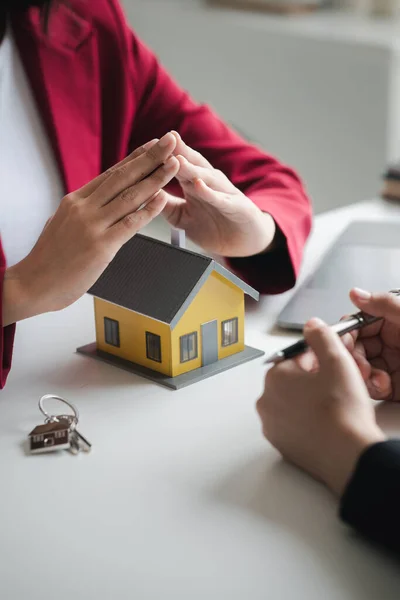House sales representatives, sales representatives recommend housing details in the project to customers who are interested in viewing the houses in the project. Real estate trading concept.