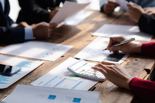 Businessman is reviewing monthly sales documents for analysis and marketing plans for more sales growth, they are the founders of young companies co-founding startups. Sales management concept.