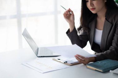 Asian women working in the office, young Asian business women as business executives, founding and running start-up executives, young female business leaders. Startup business concept.