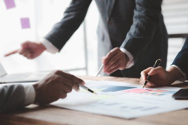 Atmosphere of a startup company meeting, business people are meeting together to summarize and plan investment finances, they are the founders of the company. Business administration concept.