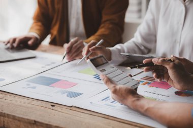 The sales department is having a monthly summary meeting to bring it to the department manager, they are verifying the correctness of the documents that are prepared before bringing in to the manager