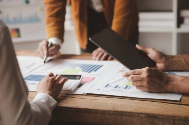 The sales department is having a monthly summary meeting to bring it to the department manager, they are verifying the correctness of the documents that are prepared before bringing in to the manager