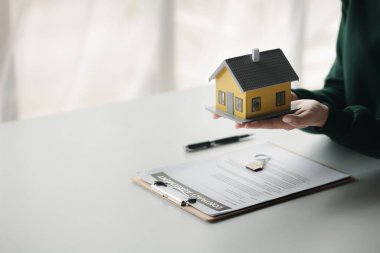 The salesperson of the housing estate in the project is preparing and verifying the contract of sale for the customer who will enter the contract. Concept of selling housing estates and real estate.