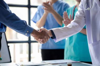 Hastanedeki konferans odası, bir grup doktorun el sıkışma toplantısına katılması, yönetici doktorların ve şeflerin ilaç satıcılarıyla buluşması. Doktor toplantısı konsepti.