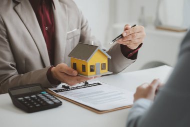 Emlakçılar, konut modellerini müşterilere ayrıntılı bir şekilde anlatma, evler ve satın alma kredileri hakkında bilgi verme ve sunma konularında açıklar. Gayrimenkul ticareti.