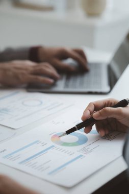 The sales department is having a monthly summary meeting to bring it to the department manager, they are verifying the correctness of the documents that are prepared before bringing in to the manager