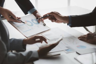 Atmosphere of a startup company meeting, business people are meeting together to summarize and plan investment finances, they are the founders of the company. Business administration concept.