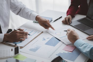 Atmosphere of a startup company meeting, business people are meeting together to summarize and plan investment finances, they are the founders of the company. Business administration concept.