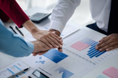 Bir grup yeni başlayan iş adamı el ele tutuşuyor, iş toplantıları, şirket satış toplantıları, beyin fırtınası ve şirket performansının özeti. İş stratejisi yönetim kavramı.