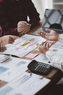 Company meeting room has businessmen and finance managers meeting together on finance topics, they are looking at information on documents and discussing together. Concept company financial management