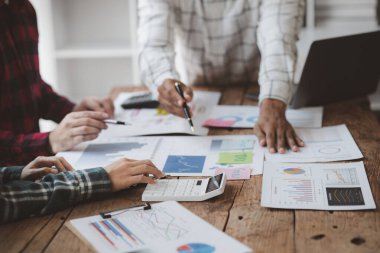 Company meeting room has businessmen and finance managers meeting together on finance topics, they are looking at information on documents and discussing together. Concept company financial management