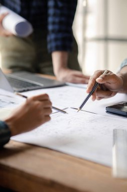 Architects and engineers are working together to edit the draft house plan that was designed after it was presented to the client and partially revised the design. Interior design and decoration ideas