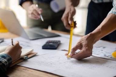 Architects and engineers are working together to edit the draft house plan that was designed after it was presented to the client and partially revised the design. Interior design and decoration ideas