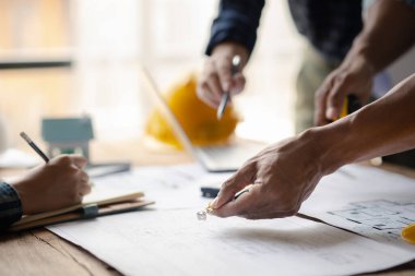 Architects and engineers are working together to edit the draft house plan that was designed after it was presented to the client and partially revised the design. Interior design and decoration ideas