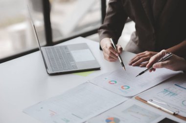 The sales department is having a monthly summary meeting to bring it to the department manager, they are verifying the correctness of the documents that are prepared before bringing in to the manager