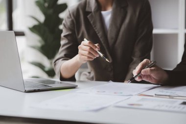 The sales department is having a monthly summary meeting to bring it to the department manager, they are verifying the correctness of the documents that are prepared before bringing in to the manager