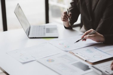 The sales department is having a monthly summary meeting to bring it to the department manager, they are verifying the correctness of the documents that are prepared before bringing in to the manager