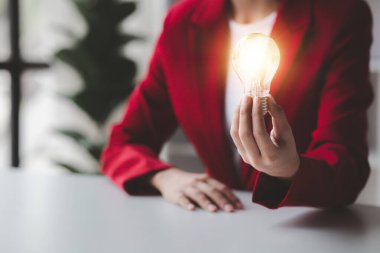 Person holding glowing lamp, Creative new idea. Innovation, brainstorming, strategizing to make the business grow and be profitable. Concept execution, strategy planning and profit management.