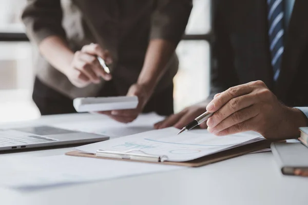 stock image Businessman is reviewing monthly sales documents for analysis and marketing plans for more sales growth, they are the founders of young companies co-founding startups. Sales management concept.