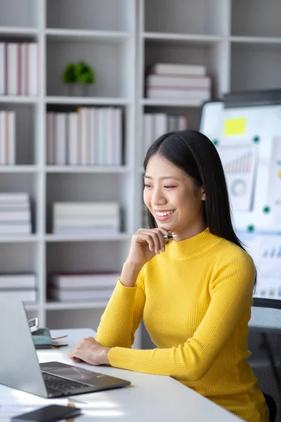 stock image A young woman is a start-up businesswoman, she sits in the office, managing and running a business from a young generation. Startup business management concept.
