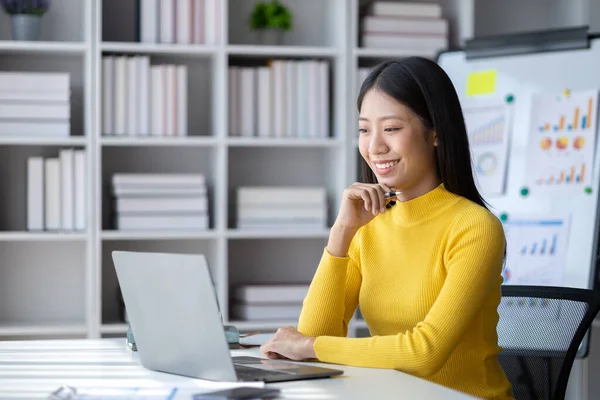 stock image A young woman is a start-up businesswoman, she sits in the office, managing and running a business from a young generation. Startup business management concept.