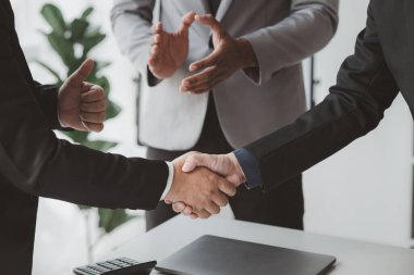 Business investor group holding hands, Two businessmen are agreeing on business together and shaking hands after a successful negotiation. Handshaking is a Western greeting or congratulation.