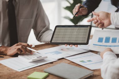 The sales department is having a monthly summary meeting to bring it to the department manager, they are verifying the correctness of the documents that are prepared before bringing in to the manager