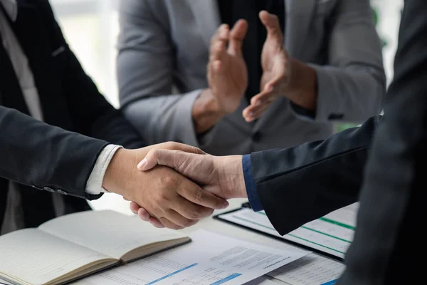 stock image Business investor group holding hands, Two businessmen are agreeing on business together and shaking hands after a successful negotiation. Handshaking is a Western greeting or congratulation.