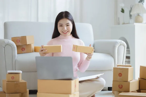 Online Seller, Young Asian store owner, she makes a living selling products online, live selling on social media platforms to reach target audience. Concept of selling products online.