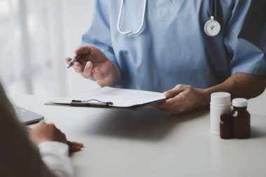 Doctors are giving advice on treatment to patients in hospital examination rooms, treating diseases from specialists and providing targeted treatment. Concepts of medical treatment and specialists.