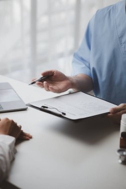 Doktorlar, hastane muayene odalarındaki hastalara tedavi, uzmanların hastalıklarını tedavi ve hedef gösterilmiş tedaviler konusunda tavsiyelerde bulunuyorlar. Tıbbi tedavi ve uzman kavramları.